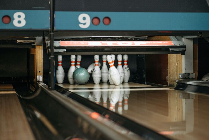 Bowling Pins Collapsing From The Impact Of The Bowling Ball 