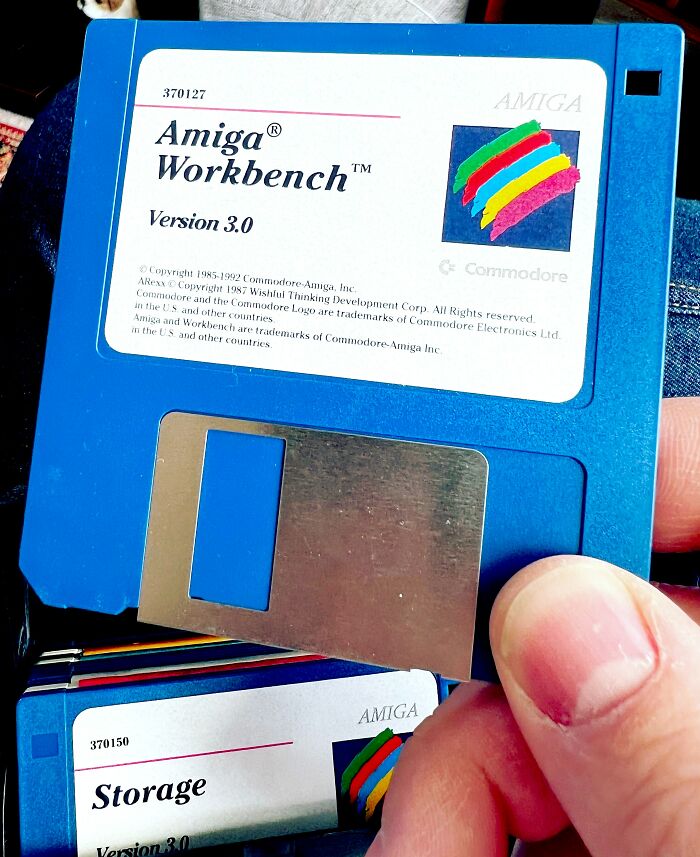 Person Holding A Floppy Disk In His Hand 