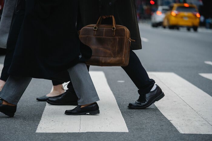 Multiple people walking on the cross walk 
