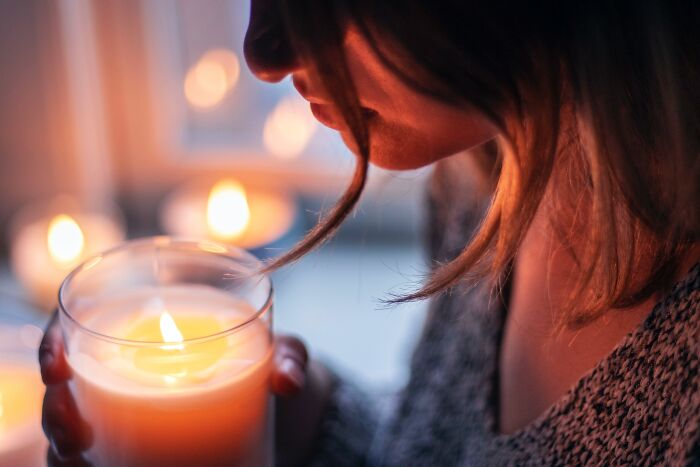 Woman holding a lit up candle 