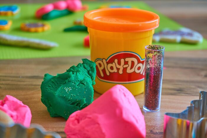 Play-doh container with Play-doh outside as well 