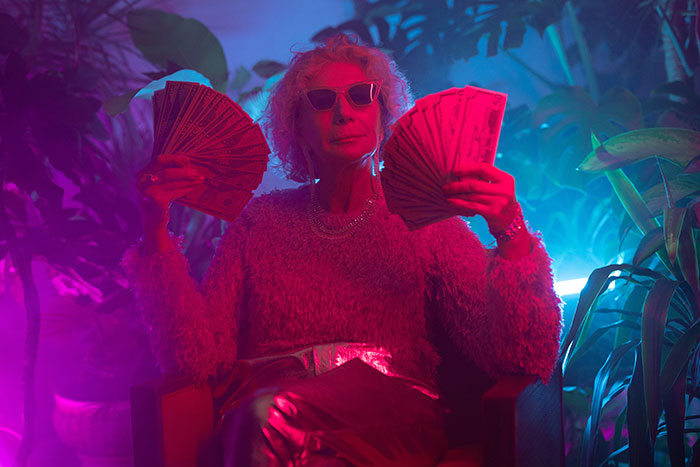 Woman using money as a hand fan