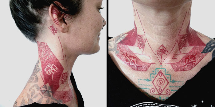 Neck adorned with intricate red ink tattoos featuring geometric patterns on a woman's skin.
