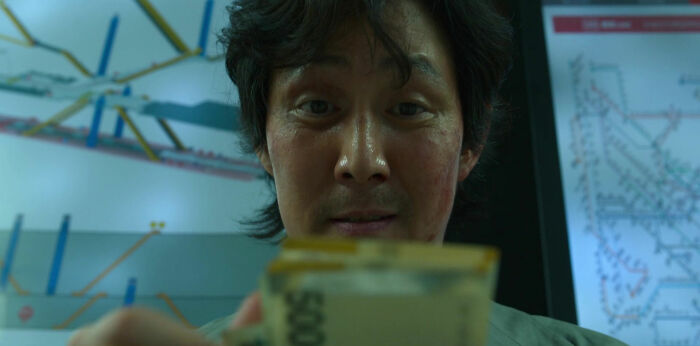 Man looking down and counting money 