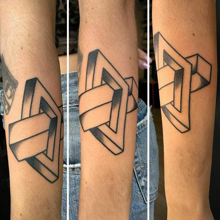 Optical illusion tattoo of a 3D geometric shape on the arm, creating a visual trick with shading and design.