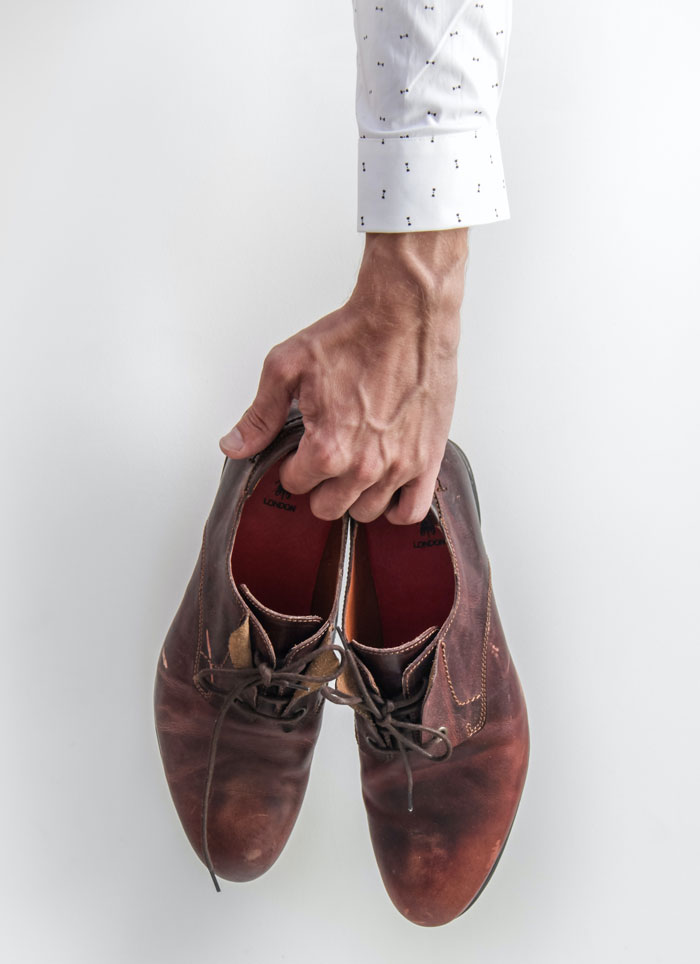 Man holding shoes