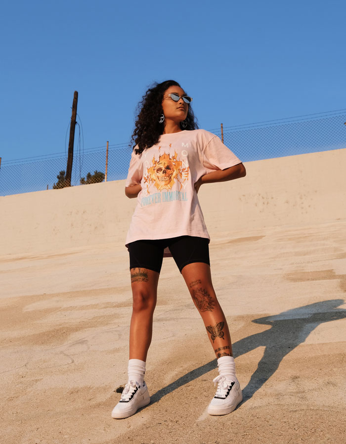 Woman standing and wearing pink shirt