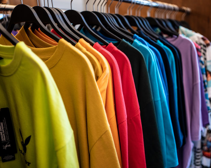 Different color clothes on hangers