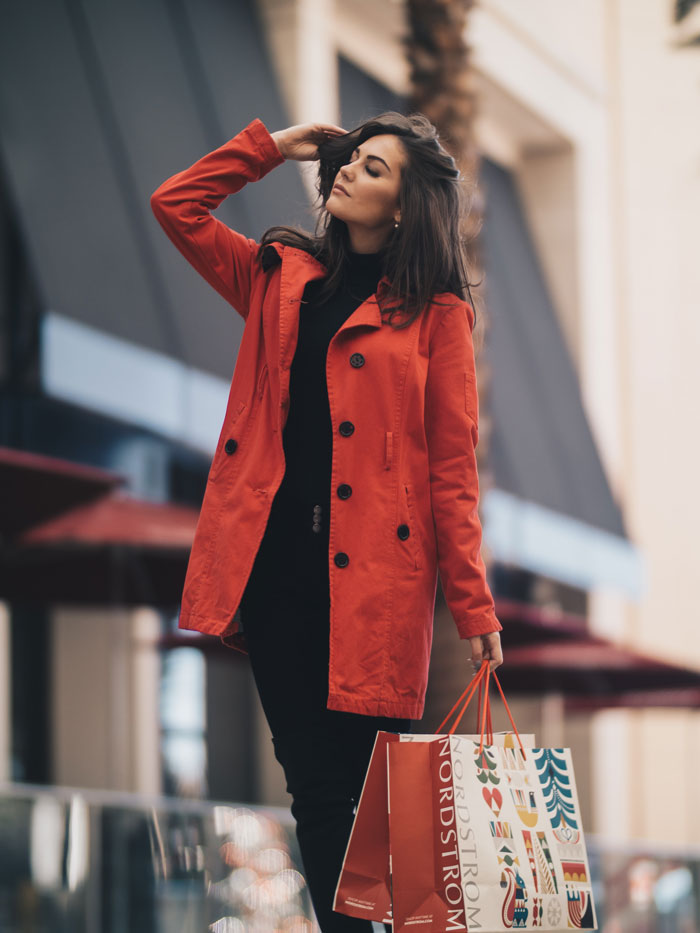 Woman standing and wearing red jacket