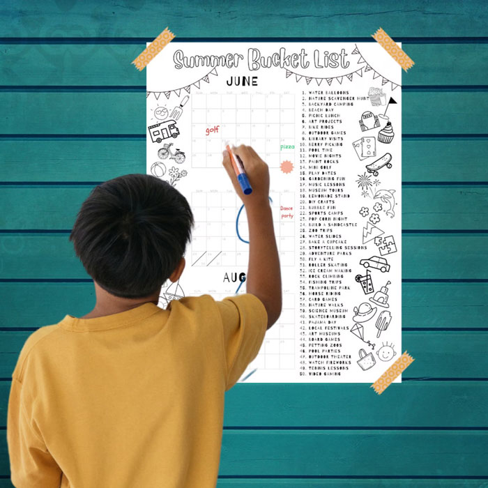 Boy writing down summer bucket list 