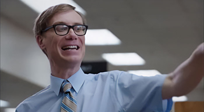 Neil from Accounting wearing blue shirt and a tie 