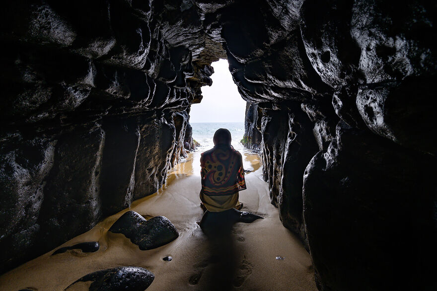 "A Woman Prays In The Grotto Of The Layenne Brotherhood"