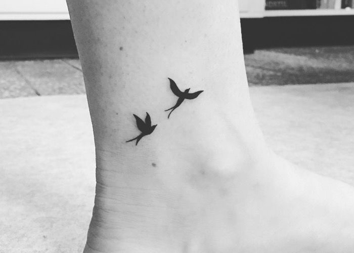 Minimalistic bird tattoos on ankle, a design noted for lacking creativity.