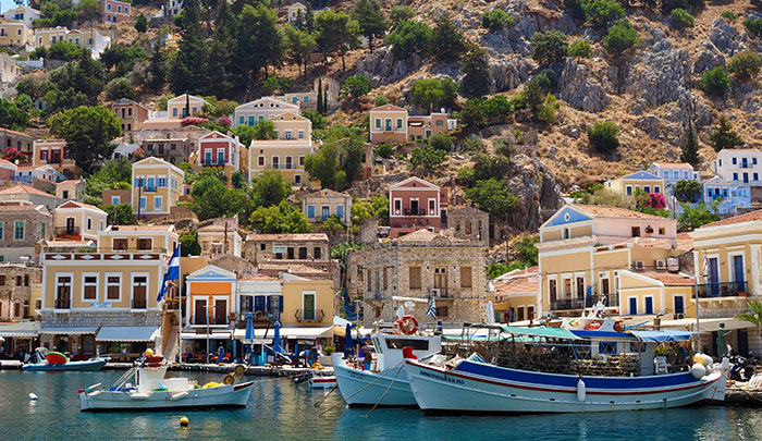 Colorful buildings and boats in Symi, Greece