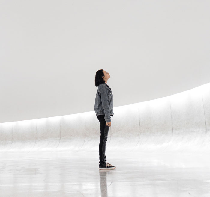 Woman in a ice skating arena looking up