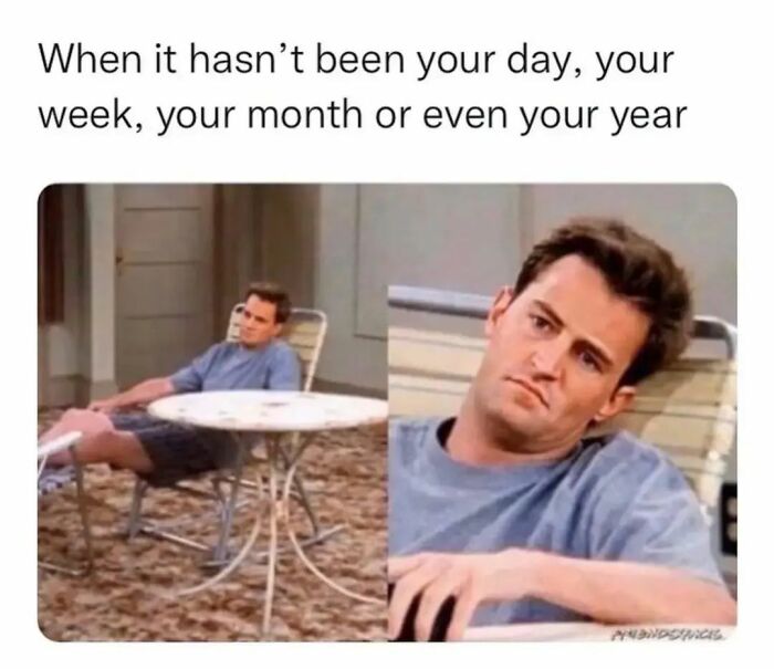 Man in a chair looking tired and frustrated, representing relatable introvert memes about bad days and weeks.