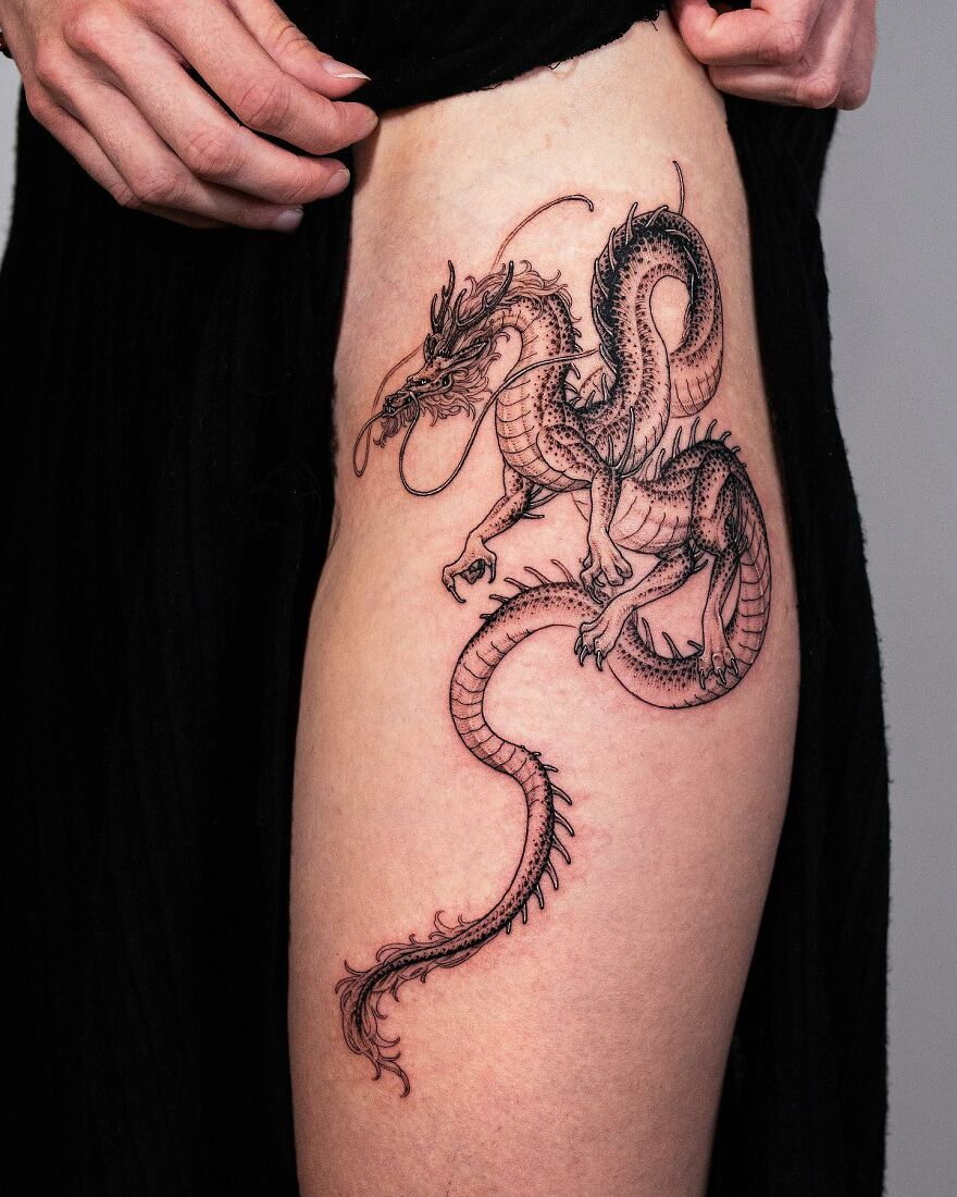 Black Ink Dragon with a long tail Tattoo Design on thigh 