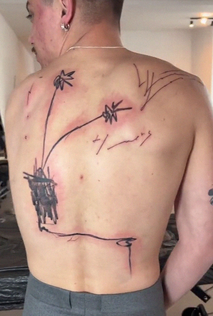 Man with abstract tattoo art on his back by viral tattoo artist. Man with abstract tattoo art on his back by viral tattoo artist.
