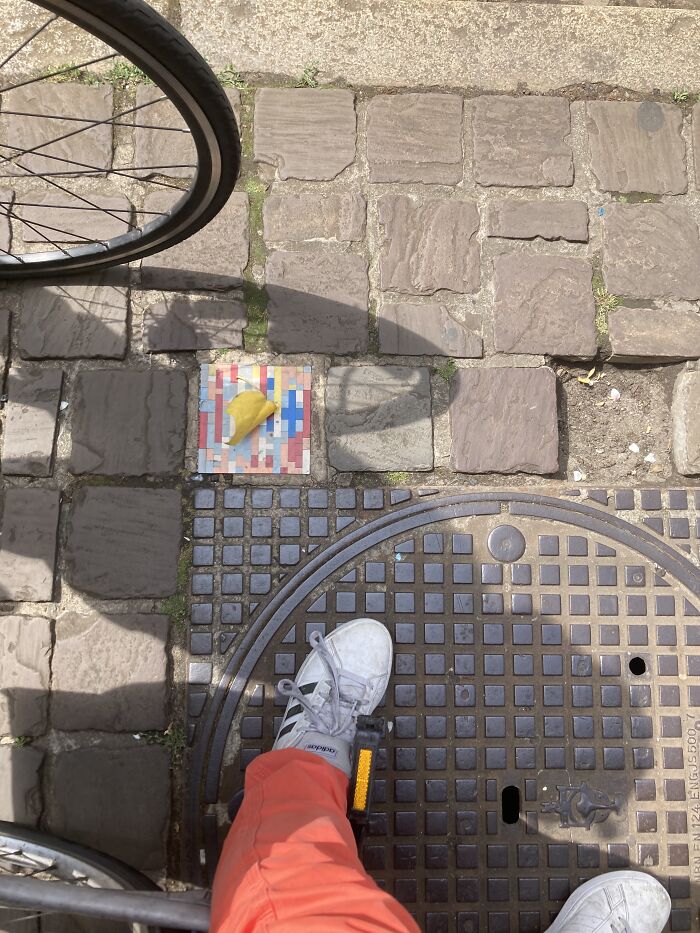 Someone Fixing Holes In Pavement With LEGO Bricks. Antwerp