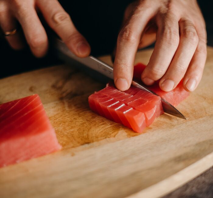 Chef Cutting Fresh Tuna Into Slices 