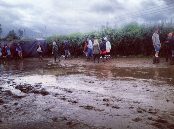 Mud and people walking at Isle Of Wight, 2012 festival