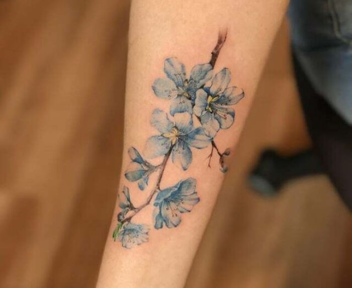 Watercolor blue flower hand tattoo