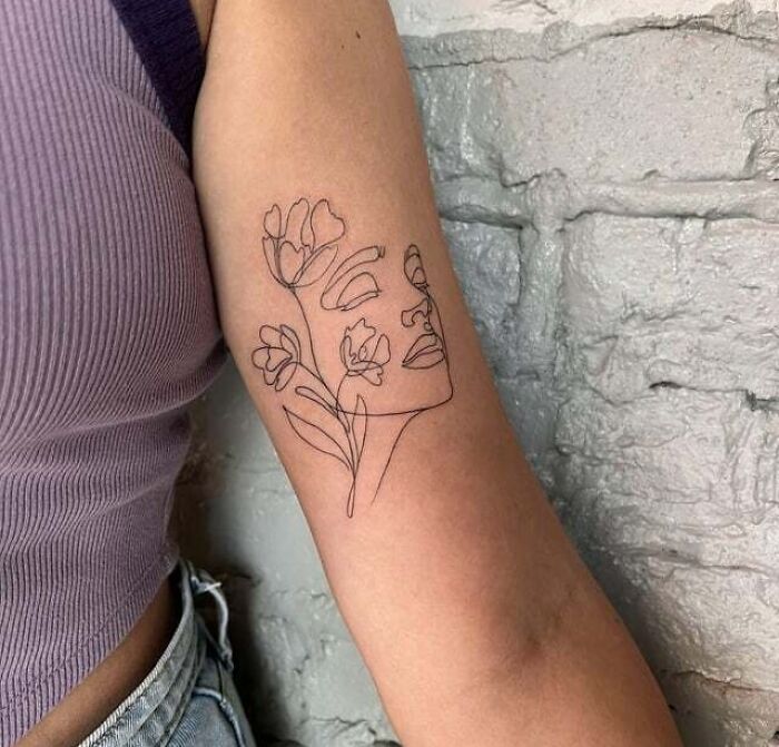 Woman’s Face With Flowers tattoo