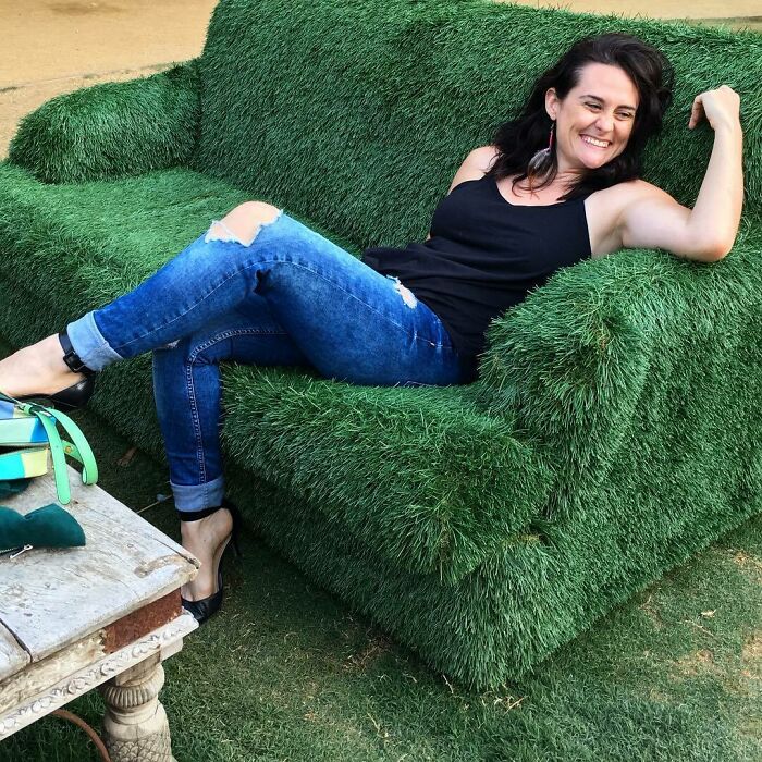 Woman sitting in the fake grass chair 