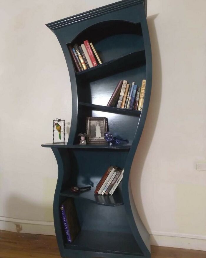 Curved dark blue book shelf 