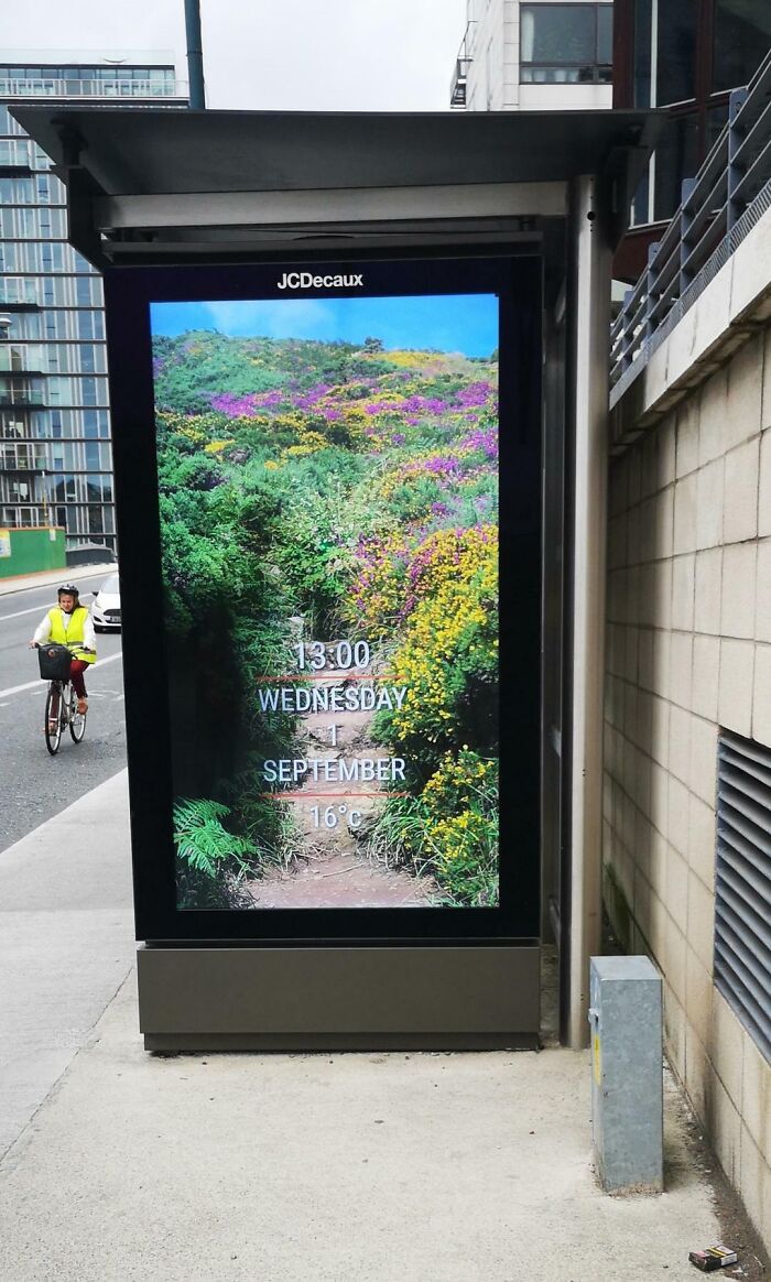 This Bus Stop Has A Digital Poster Space That Gives The Time, Day, Date, And Temperature