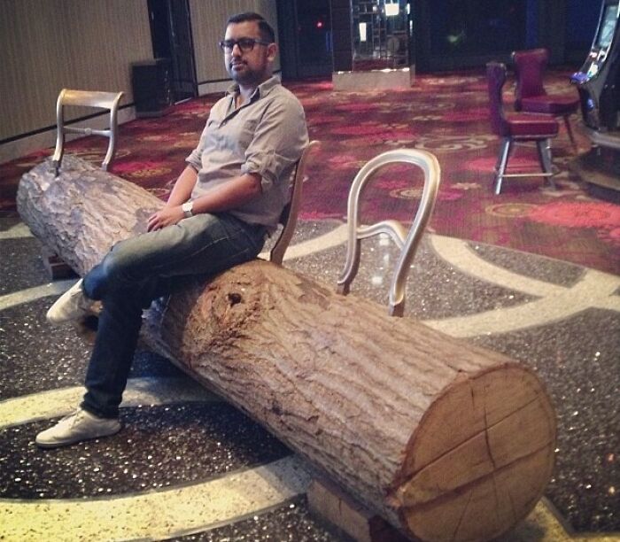Man sitting on the chair made from tree trunk