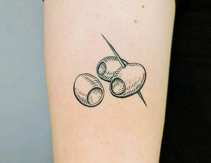 Three olives tattoo featuring detailed ink artwork, showcasing food-inspired tattoo creativity.