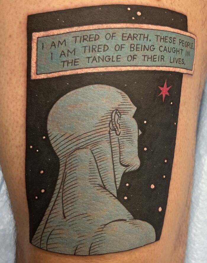 Pop culture tattoo of a comic-style figure with a starry background and a quote about Earth and life.