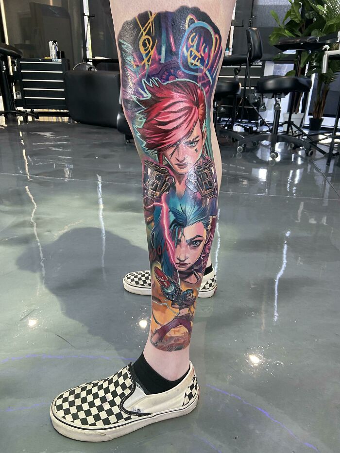 Colorful pop culture tattoo sleeve featuring anime characters on a person's leg in a tattoo studio.