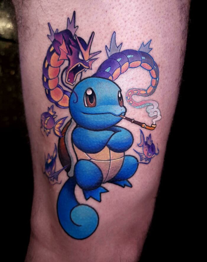 Colorful pop culture tattoo of a blue cartoon character smoking, surrounded by vibrant creatures on skin.
