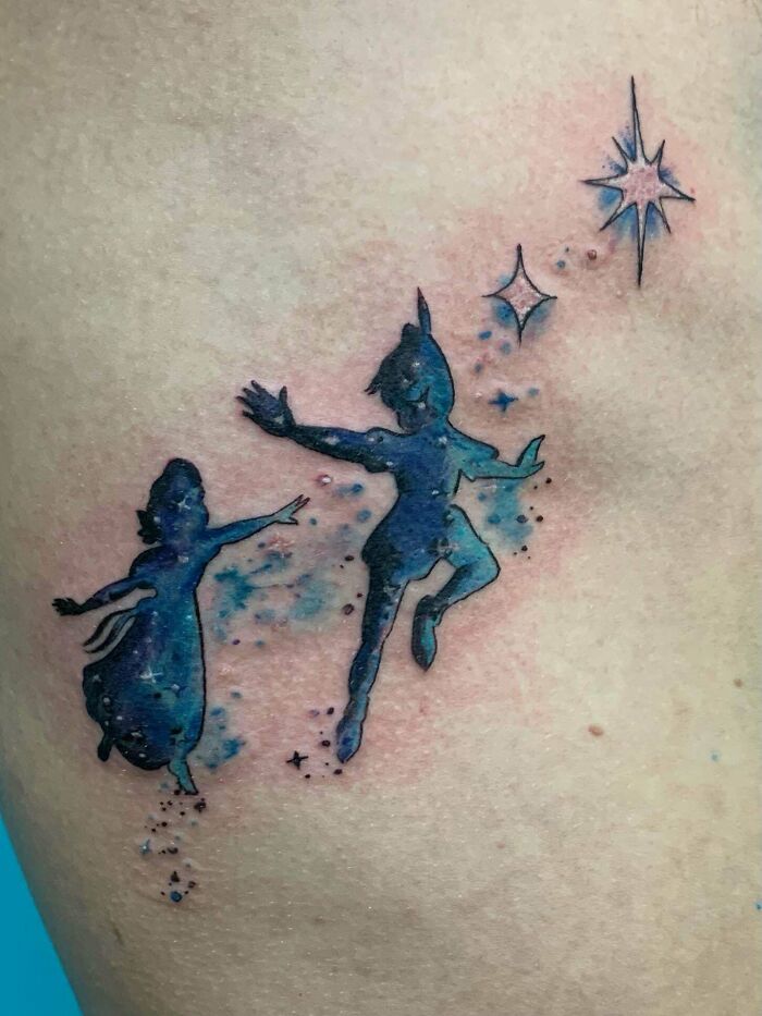Silhouettes of characters in a galaxy-themed design, a unique pop culture tattoo.