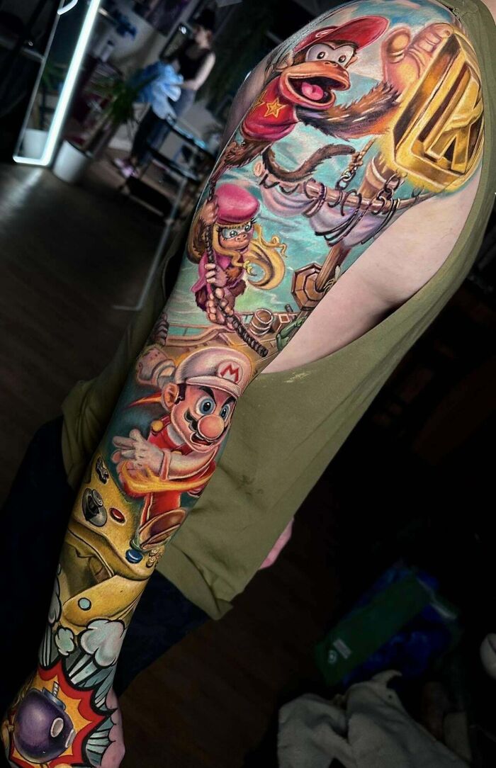 Colorful pop culture tattoo sleeve featuring classic video game characters.