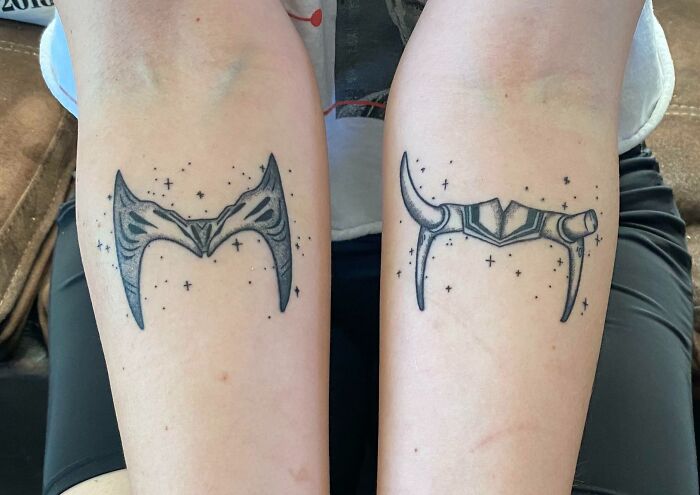 Pop culture tattoos featuring two detailed horn designs on forearms, surrounded by small stars.