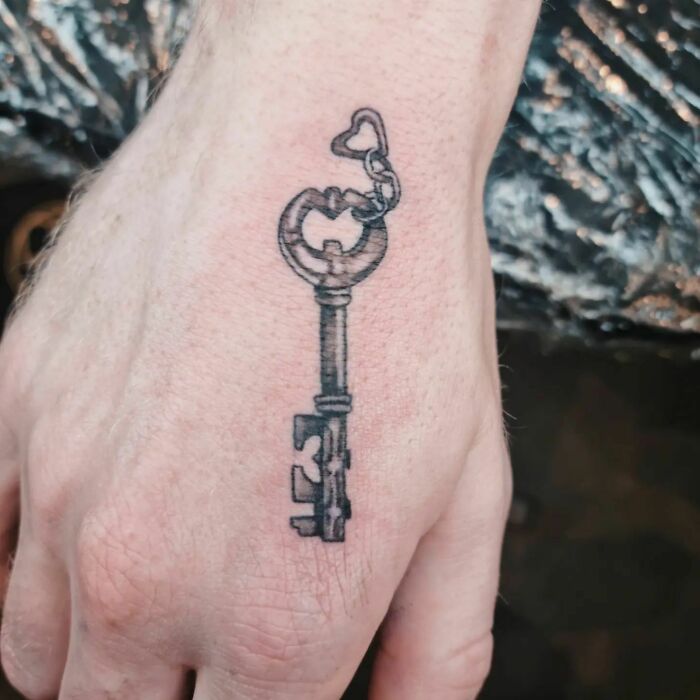 Key tattoo on hand