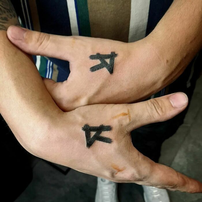 Black R letter tattoos on hands