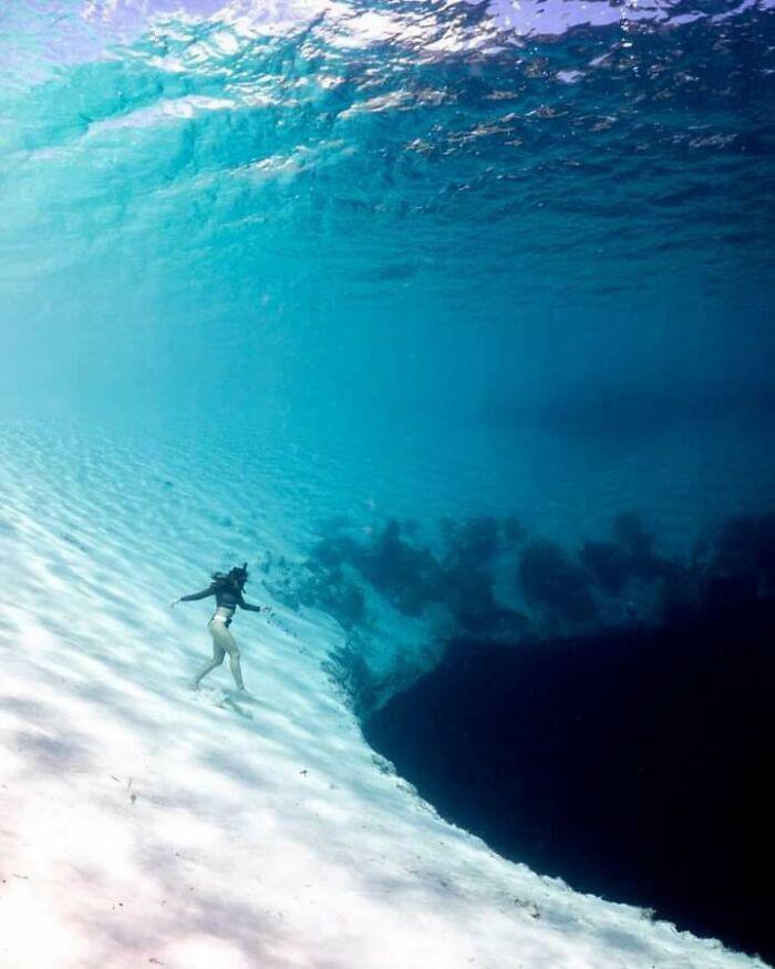 A Diver Walking Towards An Abyss