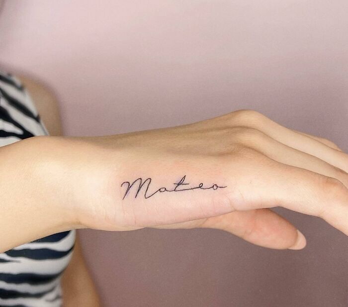 Lettering tattoo on hand