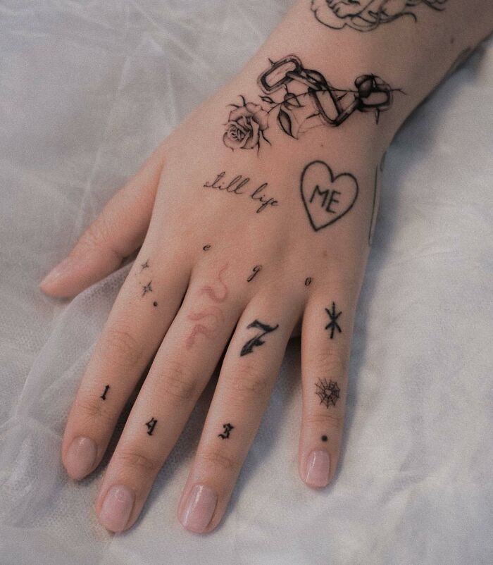 Many different small tattoos on hand