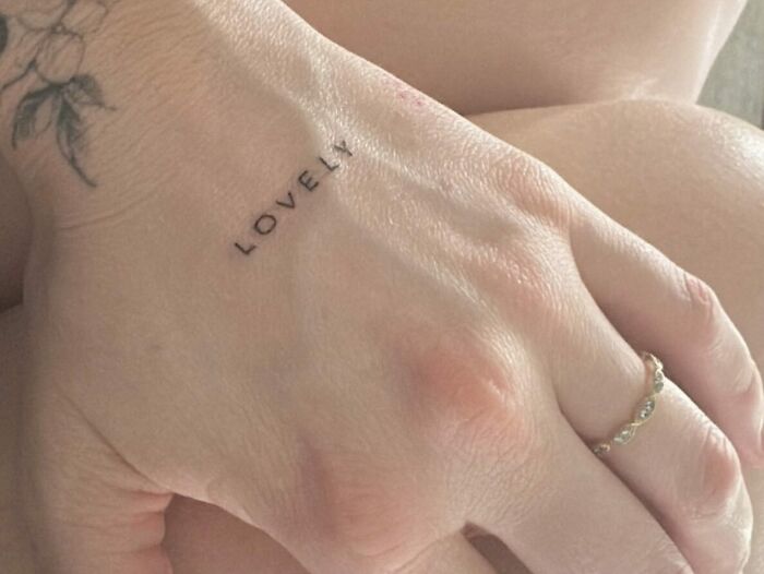 Lettering ‘Lovely’ tattoo on hand