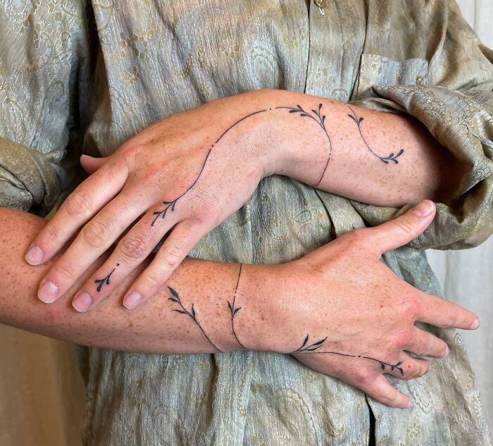 Minimal vine tattoos on hands and arms