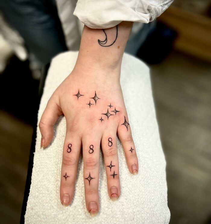 ‘8 8 8’ number tattoos on finger and stars tattoos on hand
