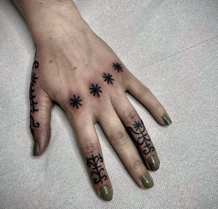 Black ornamental hand tattoos