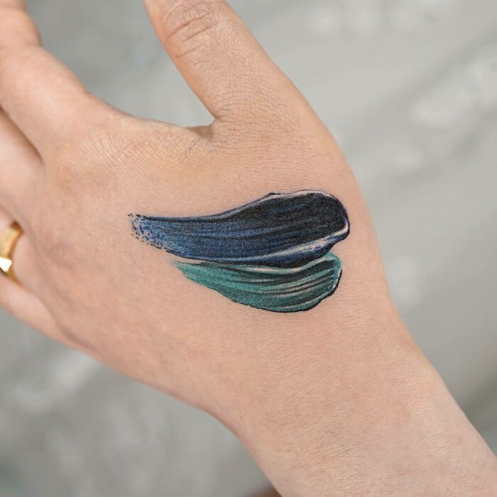 Realistic paint color strokes tattoo on the hand