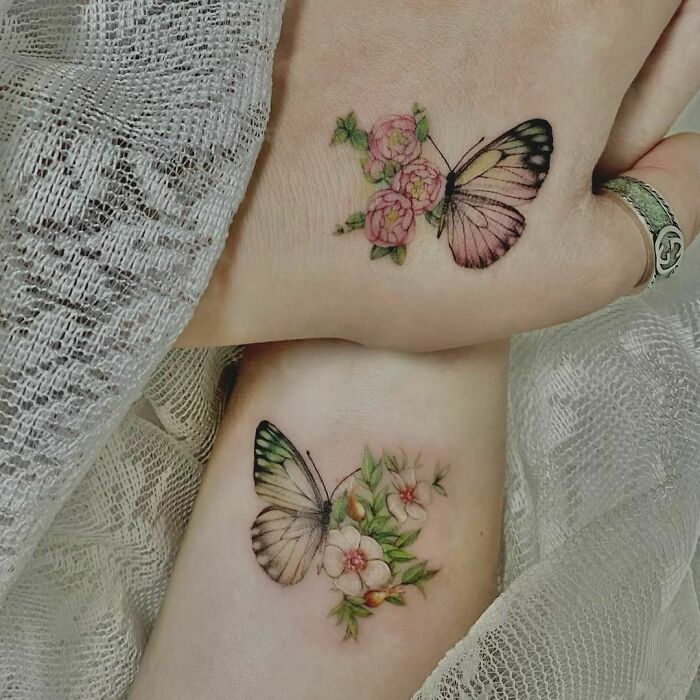 Butterflies and flowers tattoos on hands