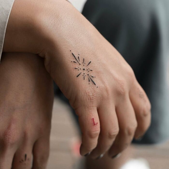 Minimal ornamental tattoo on hand